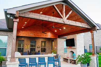 Backyard patio photo in Dallas with a fireplace