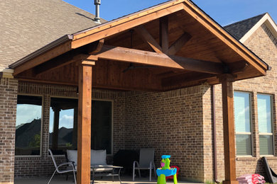 Patio - small rustic backyard concrete patio idea in Dallas with a gazebo