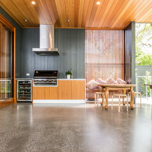 Inspiration for a contemporary backyard patio in Brisbane with an outdoor kitchen, concrete slab and a roof extension.