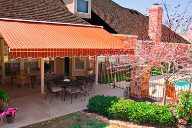 Modelo de patio clásico de tamaño medio en patio trasero con losas de hormigón y toldo