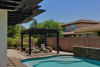 Patio - modern backyard patio idea in Phoenix with a pergola