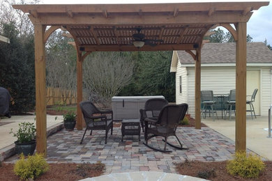 Medium sized traditional back patio in Atlanta with brick paving and a pergola.