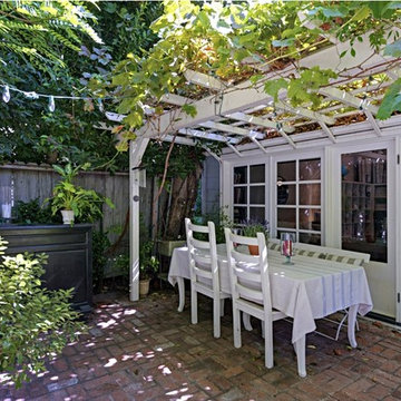 Back Brick Patio with Dining Table and Pergola