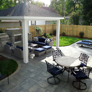 Esempio di un patio o portico contemporaneo di medie dimensioni e dietro casa con un focolare, pavimentazioni in mattoni e un gazebo o capanno