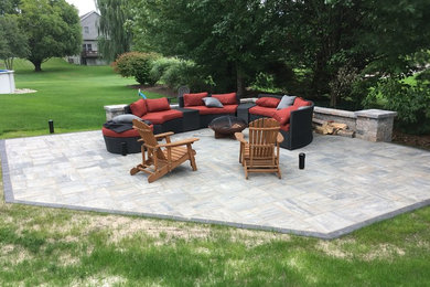 Inspiration for a backyard concrete paver patio remodel in Grand Rapids
