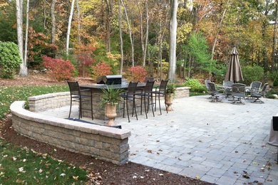 Inspiration for a medium sized contemporary back patio in Boston with an outdoor kitchen, concrete paving and no cover.