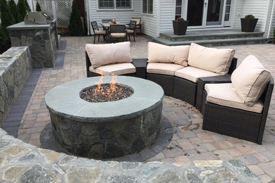 Mid-sized transitional backyard concrete paver patio photo in Orange County with a fire pit and no cover