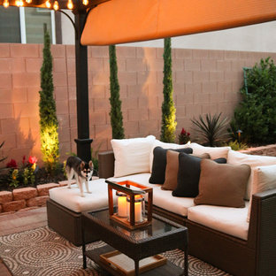 Patio - small transitional backyard concrete paver patio idea in Las Vegas with a pergola