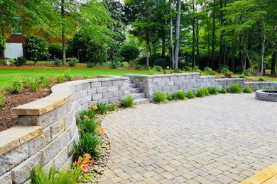 Patio - large contemporary backyard concrete paver patio idea in Other with a fire pit and no cover
