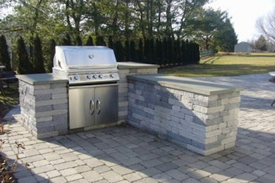 Backyard concrete paver patio kitchen photo in Philadelphia with no cover