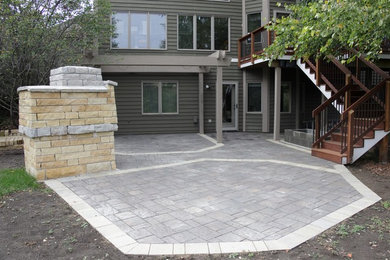 Patio - large traditional backyard concrete paver patio idea in Minneapolis