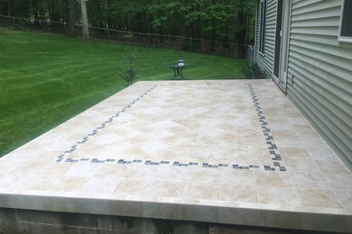 Inspiration for a mid-sized modern backyard tile patio remodel in Other