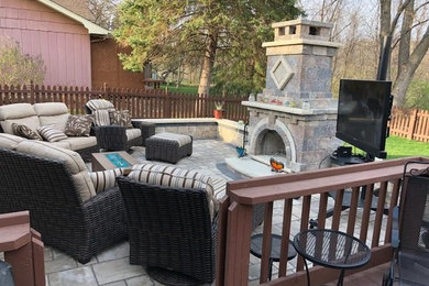 Design ideas for a traditional patio in Chicago with a fire feature and brick paving.
