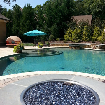Backyard patio, pool, hot tub, and gas fire pit.