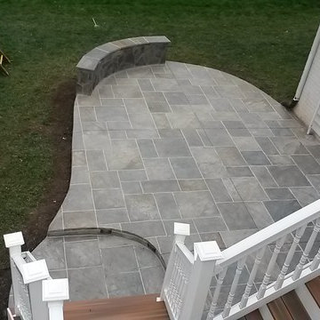 Backyard patio wtih Multi-Color & grouted stamped concrete, with stone sitting w