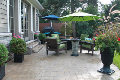 Mid-sized trendy backyard stone patio photo in Toronto