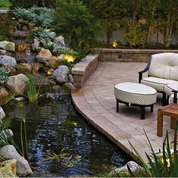 Backyard Pond and Patio with a Rock Waterfall