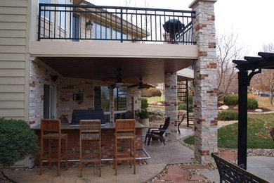 Example of an arts and crafts patio design in Omaha