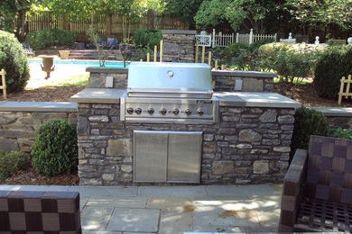 Large classic back patio in Atlanta with a fire feature, concrete paving and no cover.