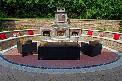 Inspiration for a large timeless backyard brick patio remodel in Chicago with a fire pit