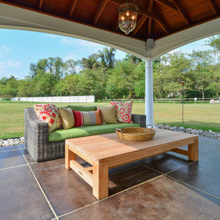 Design ideas for an expansive traditional back patio in DC Metro with stamped concrete, an outdoor kitchen and a pergola.