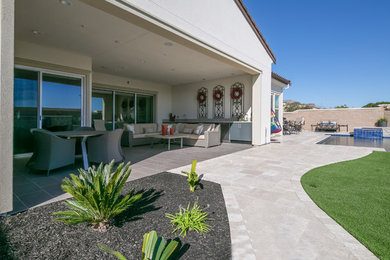 Example of a mid-sized transitional backyard stone patio design in San Francisco with a roof extension