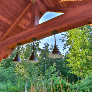 Esempio di un grande patio o portico chic dietro casa con un caminetto, pavimentazioni in cemento e un gazebo o capanno