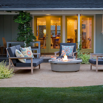 Backyard seating area with fire pit and lush planting
