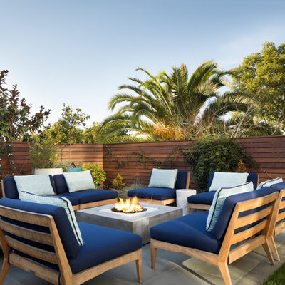 Example of a mid-sized trendy backyard concrete patio design in San Francisco with no cover and a fire pit