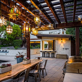 Patio kitchen - mediterranean backyard patio kitchen idea in San Francisco with a pergola