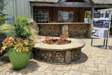 Inspiration for a mid-sized transitional concrete paver patio remodel in Atlanta with a fire pit