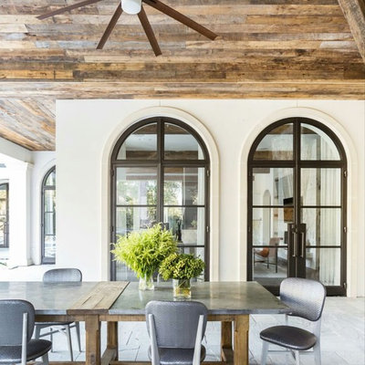 Large cottage backyard concrete paver patio kitchen photo in Houston with a roof extension