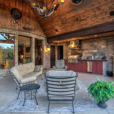 Inspiration for a large rustic backyard concrete patio remodel in Oklahoma City with a roof extension