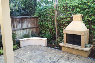 Example of a transitional concrete paver patio design in Sacramento with a fire pit and a gazebo