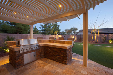 Example of a classic backyard patio kitchen design in Phoenix