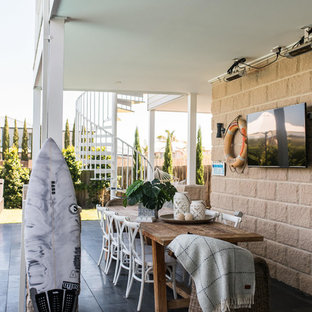 Photo of a beach style patio in Melbourne with a roof extension.