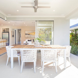 Photo of a beach style patio in Sydney with a roof extension.