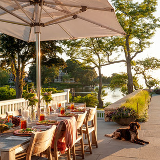 Patio - coastal backyard tile patio idea in Boston with no cover