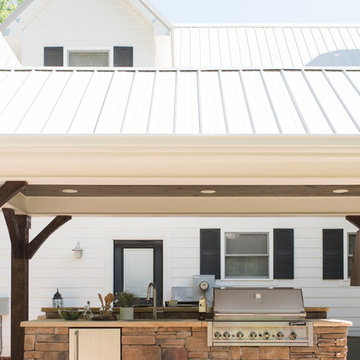 Beautiful Outdoor Kitchen under Pergola with Bar Seating