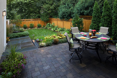 Example of a small trendy backyard concrete paver patio design in Minneapolis with no cover