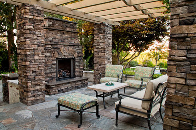 Inspiration for a backyard stone patio remodel in Boise with a fire pit