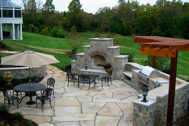 Example of a mid-sized transitional backyard concrete paver patio design in DC Metro with a fire pit and a pergola