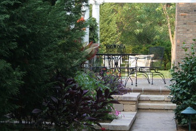 Small transitional courtyard brick patio photo in Raleigh with a pergola