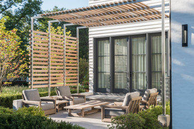 Inspiration for a contemporary side patio in Detroit with tiled flooring and a pergola.