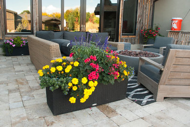 Inspiration for a contemporary front yard stone patio remodel in Boise with a fire pit