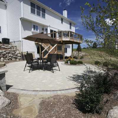 Patio - large traditional backyard concrete paver patio idea in Detroit with no cover