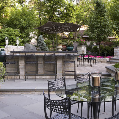 Patio kitchen - large traditional backyard stone patio kitchen idea in Chicago with no cover