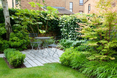 Traditional patio in London with a living wall and no cover.