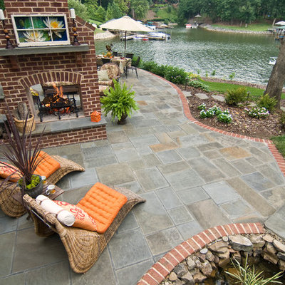 Inspiration for a transitional patio remodel in Charlotte with a fire pit