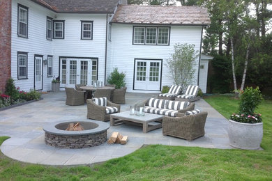 Inspiration for a backyard patio remodel in New York with a fire pit and no cover